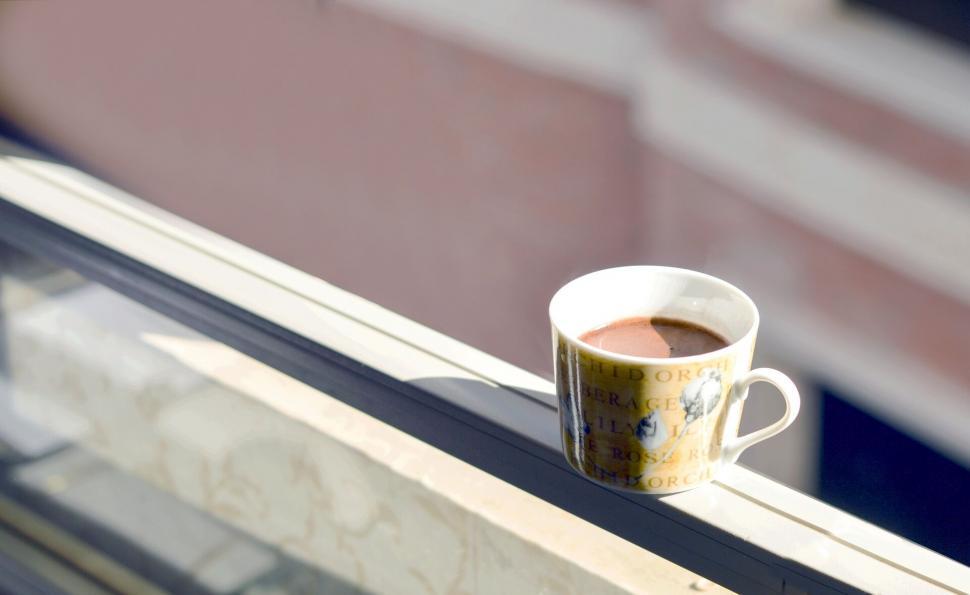 Free Image of A cup of coffee on a window sill 