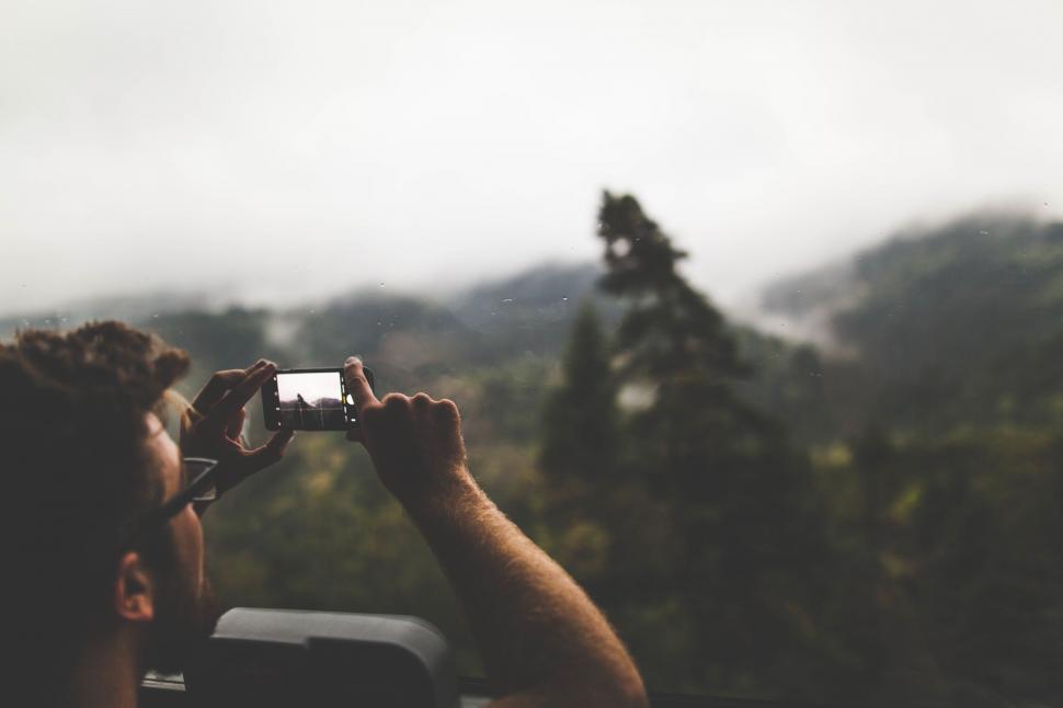 Free Image of A person taking a picture of a forest 