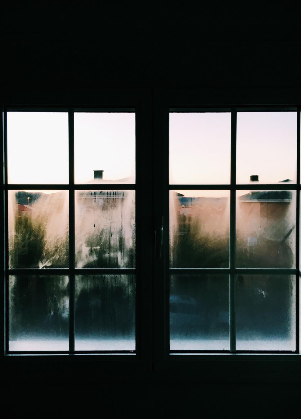 Free Image of A window with a view of a house outside 