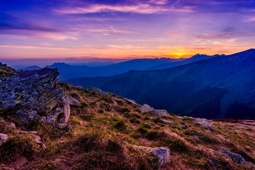Free Image of A mountain landscape with a sunset 