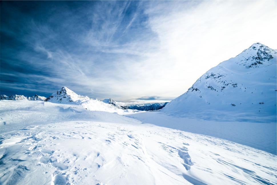 Free Image of A snowy mountain with blue sky and clouds 