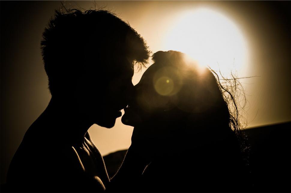 Free Image of A silhouette of a man and woman kissing 