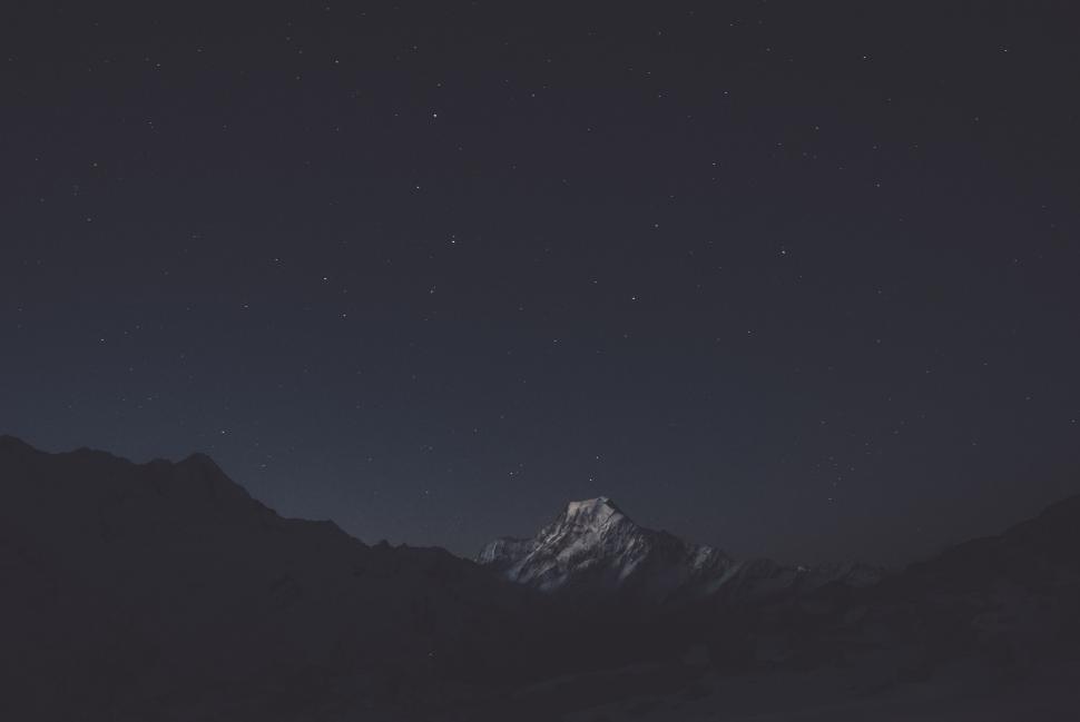 Free Image of A snowy mountain range at night 