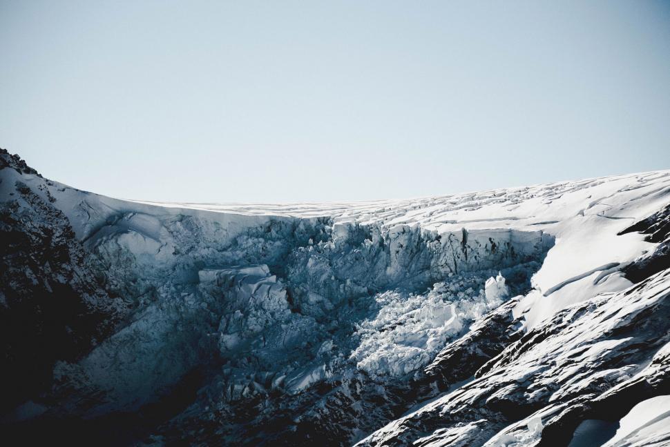 Free Image of A snow covered mountain with a cliff 