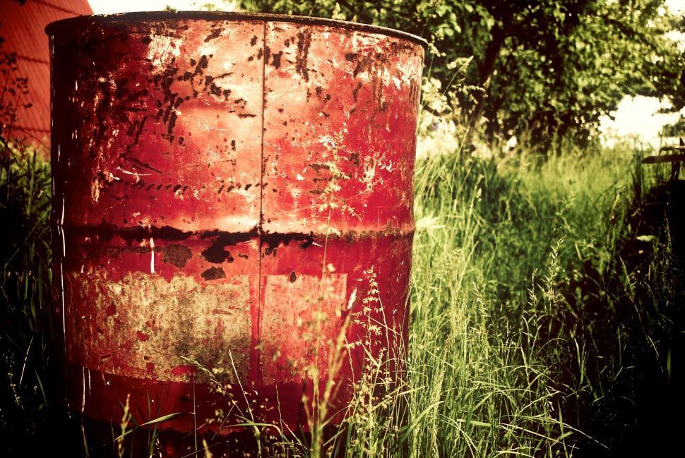 Free Image of A red barrel in tall grass 