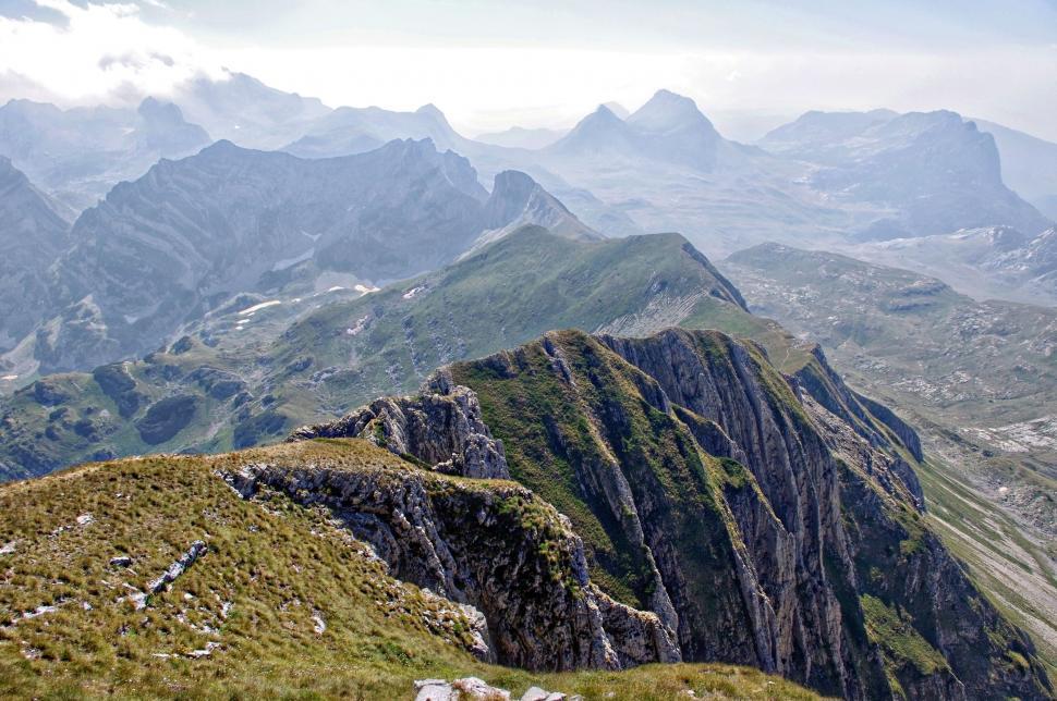 Free Image of A mountain range with a person on the side 