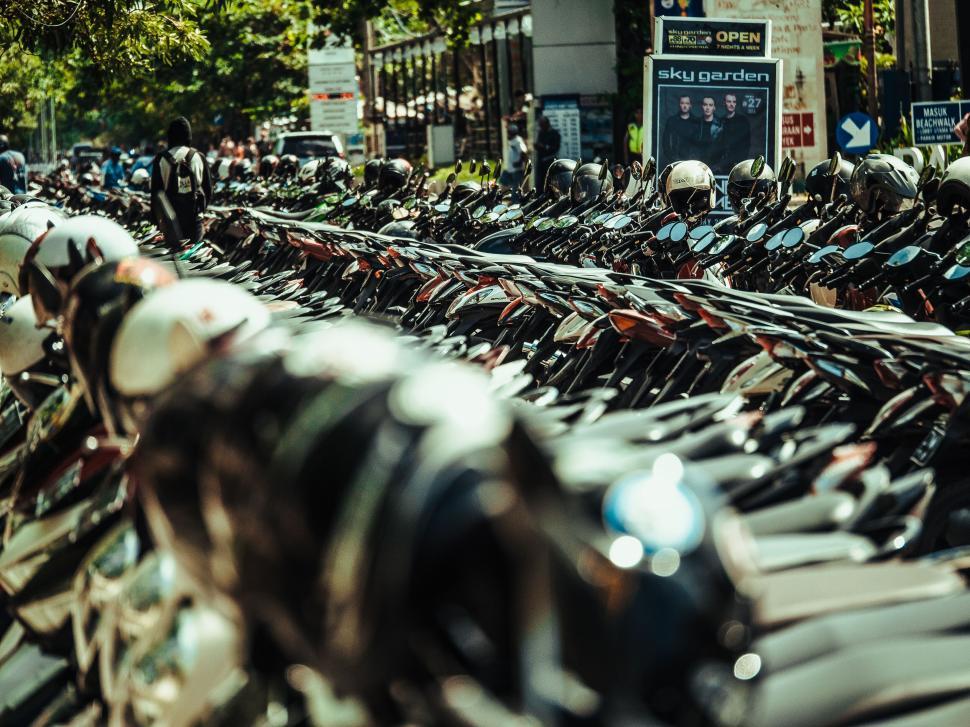 Free Image of A row of motorcycles parked on the side of a road 