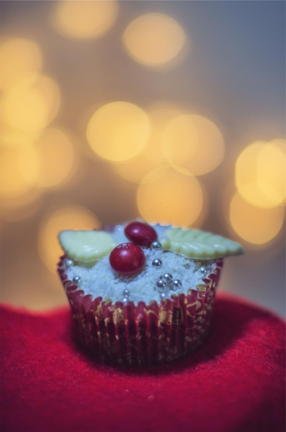 Free Image of A cupcake with a red and white frosting and candy 