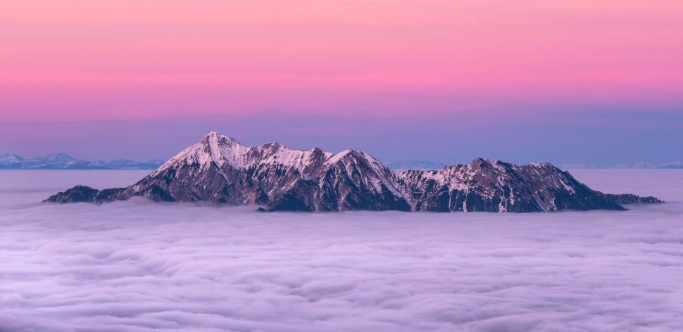 Free Image of A mountain range with clouds in the background 