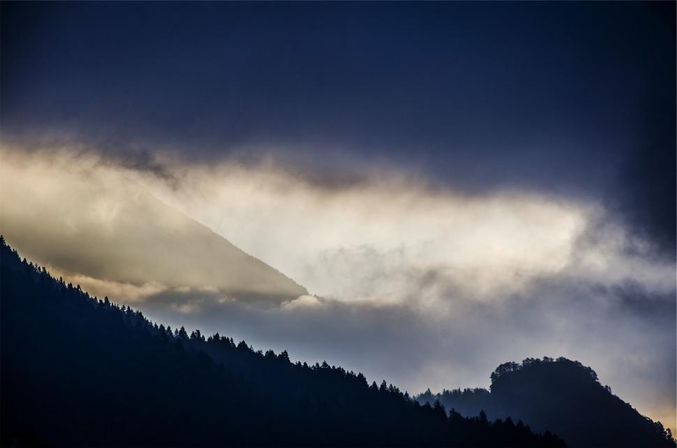 Free Image of A foggy mountain range with trees 