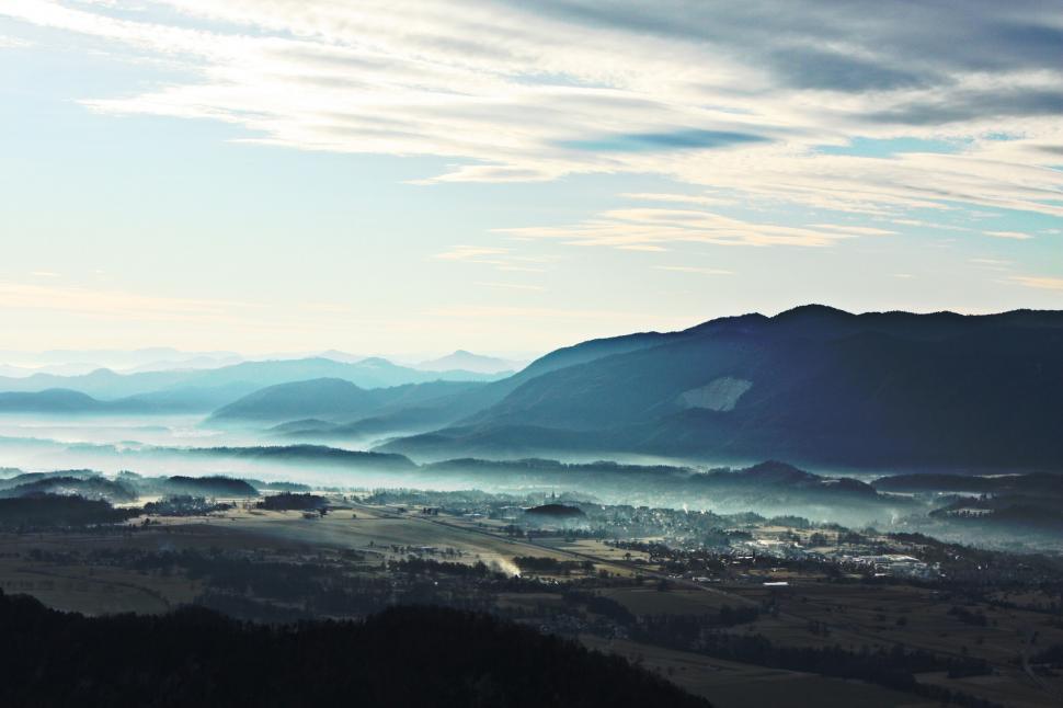 Free Image of A landscape of a valley with mountains and clouds 