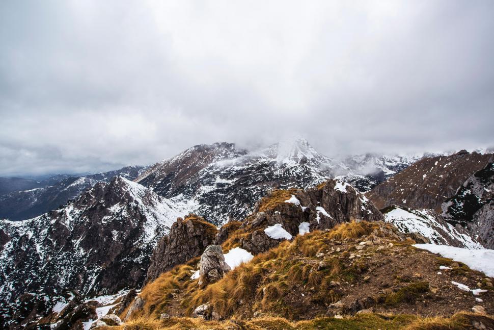 Free Image of A snowy mountain range with clouds 
