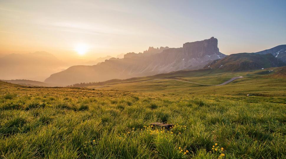 Free Image of A grassy field with a mountain in the background 