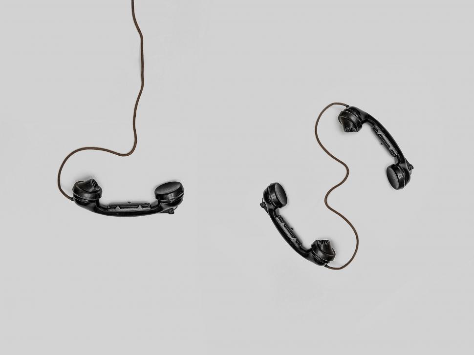 Free Image of A pair of handsets with a cord 