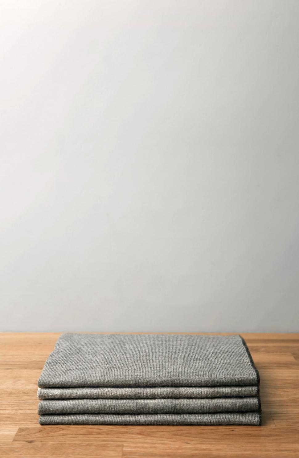Free Image of A grey square object on a wooden surface 