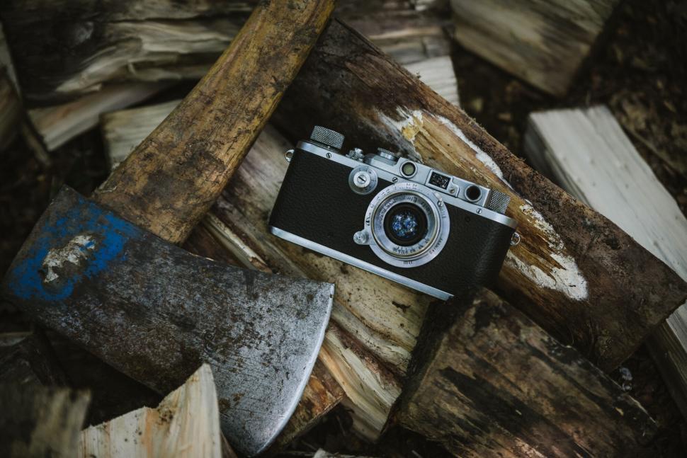 Free Image of A camera and an axe on wood 