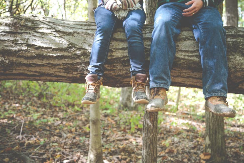 Free Image of Two people sitting on a log 