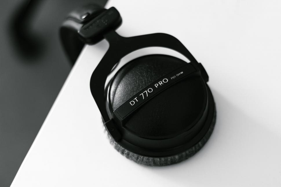 Free Image of A black headphones on a white surface 