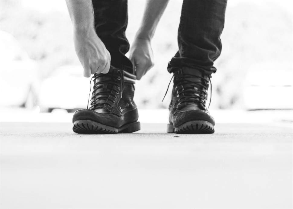Free Image of A person tying their shoes 