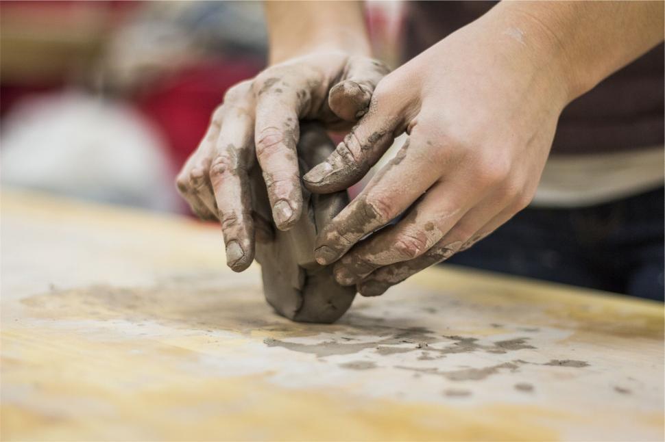 Free Image of A close up of hands holding a piece of clay 