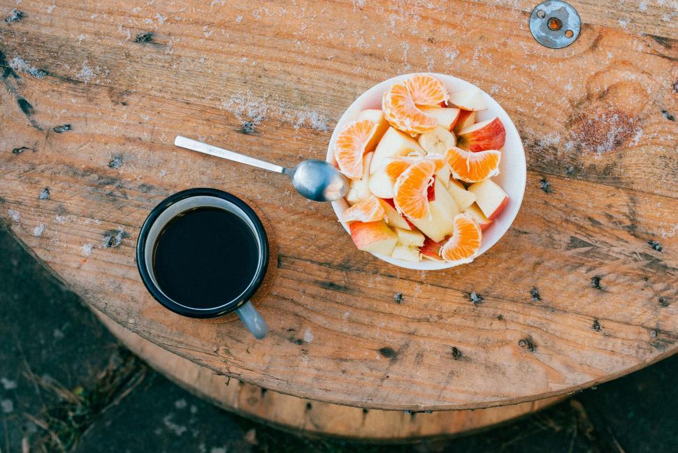 Free Image of A bowl of fruit and a cup of coffee on a table 