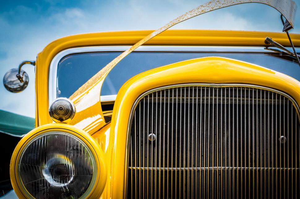 Free Image of The front of a yellow car 
