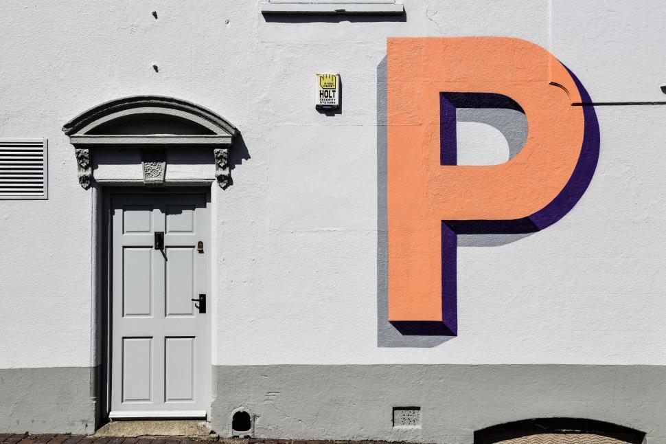 Free Image of A building with a large letter painted on it 
