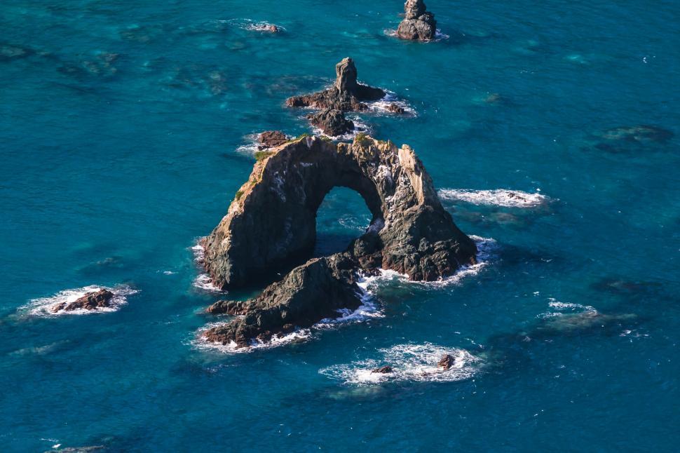 Free Image of A rock formation in the ocean 