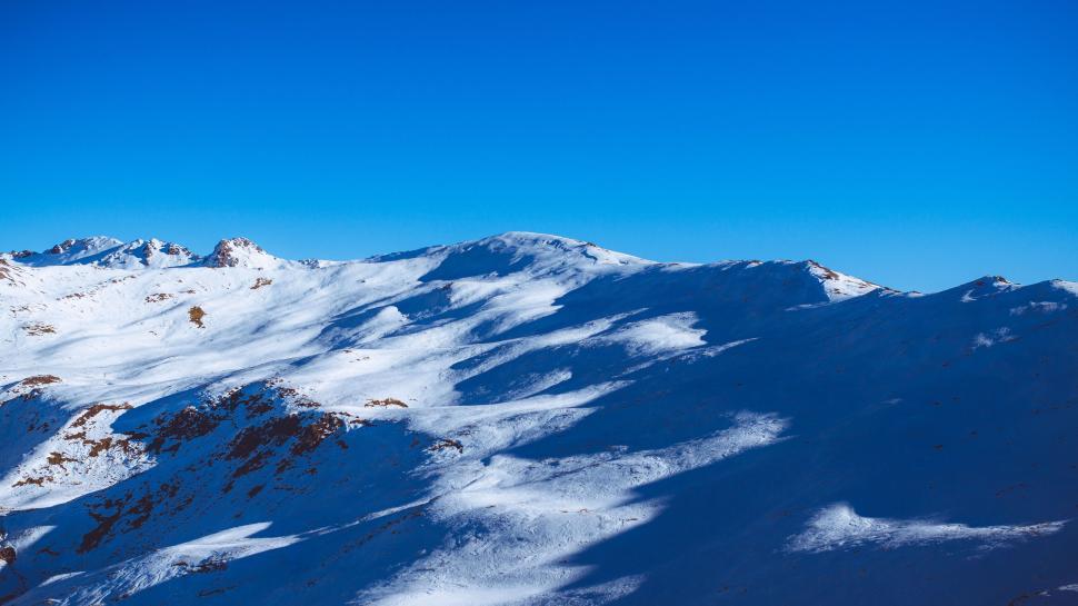Free Image of A snowy mountain with blue sky 