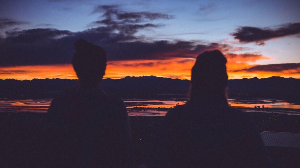 Free Image of Two people looking at a sunset 