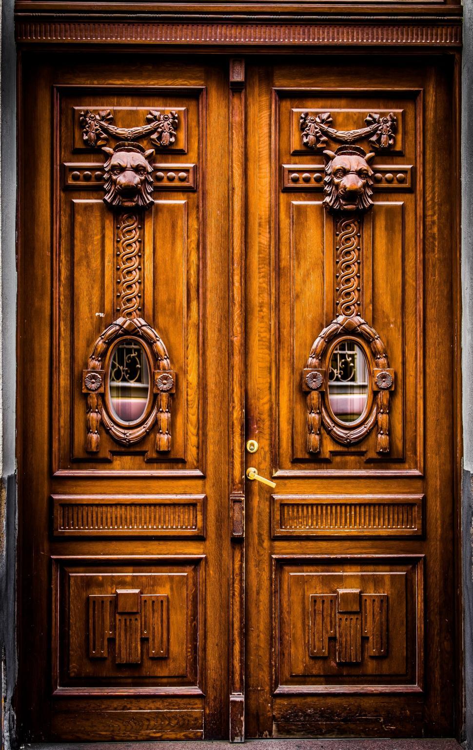 Free Image of A double door with carved wood 