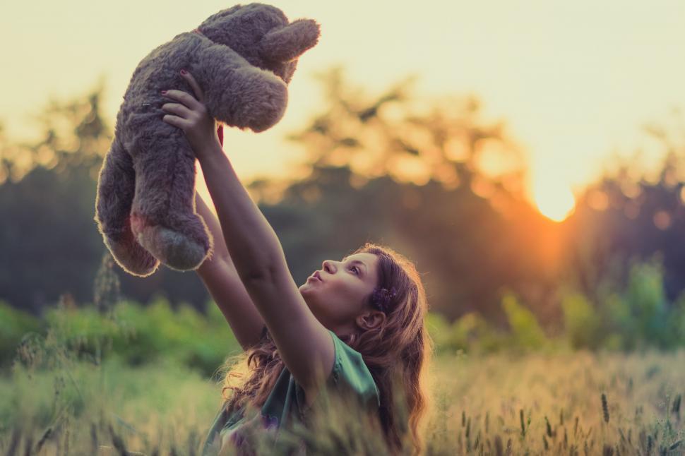 Free Image of A girl holding a teddy bear 