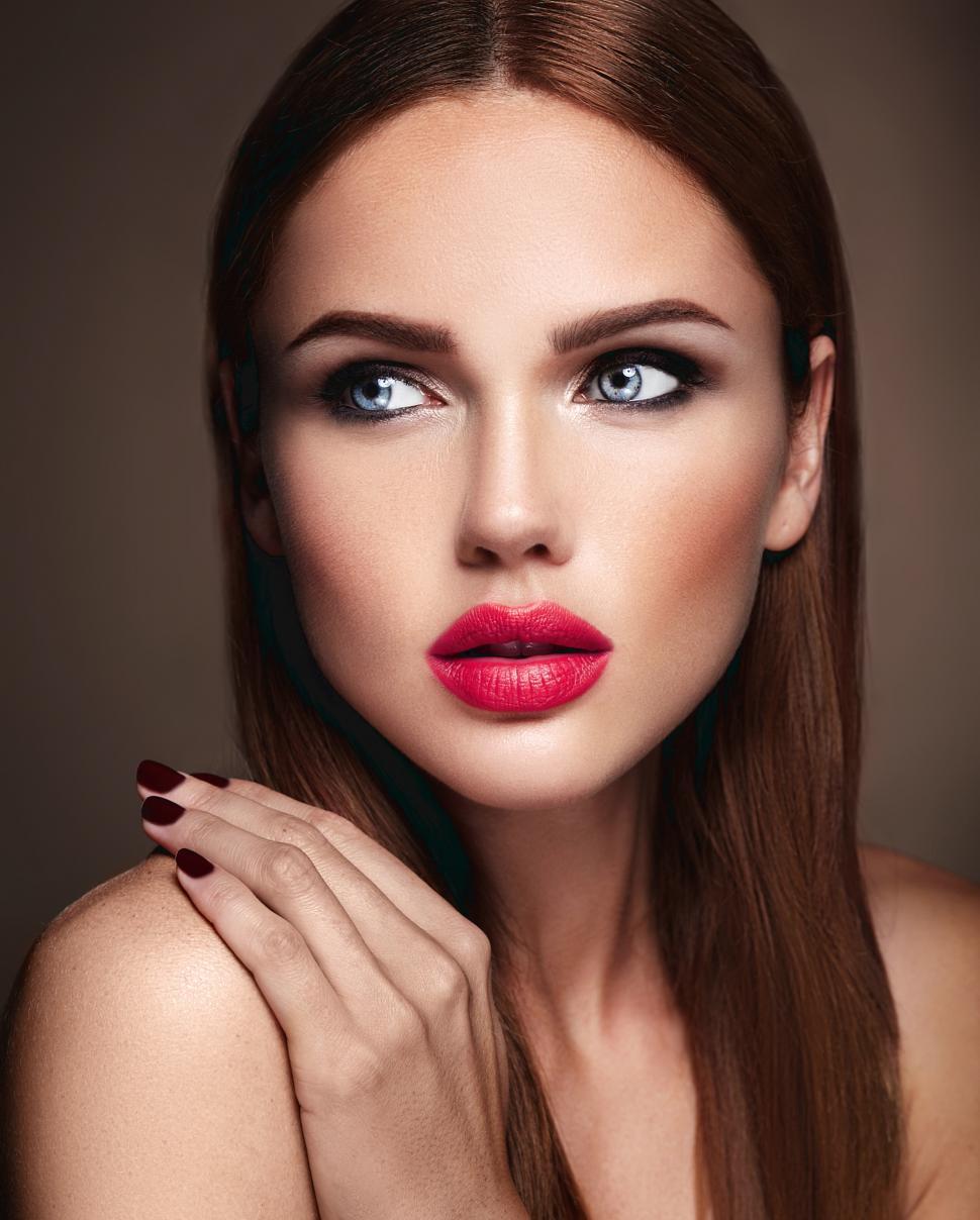 Free Image of A woman with red lips and long brown hair 