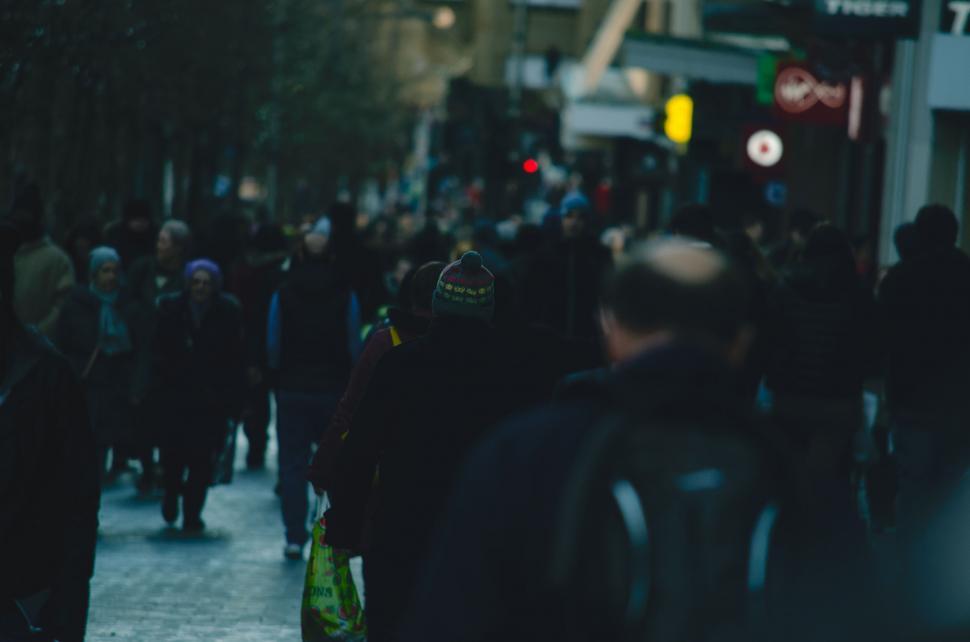 Free Image of A group of people walking down a street 