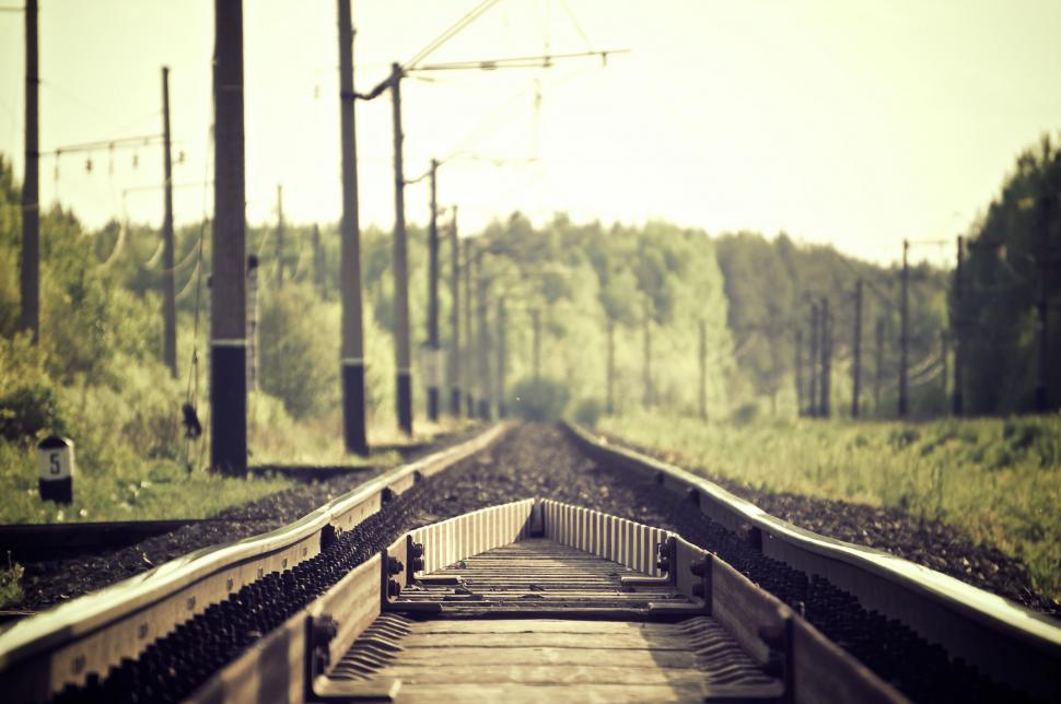 Free Image of A train track with trees in the background 