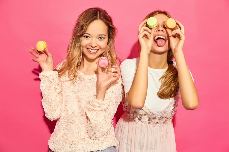 Free Image of Two women holding cookies over their eyes 