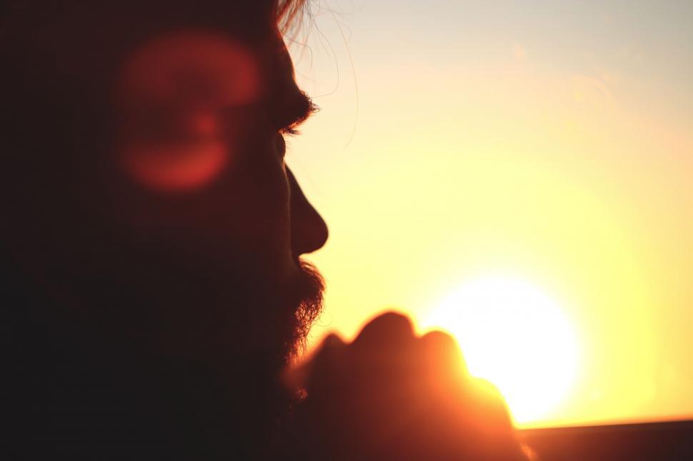 Free Image of A silhouette of a man praying 