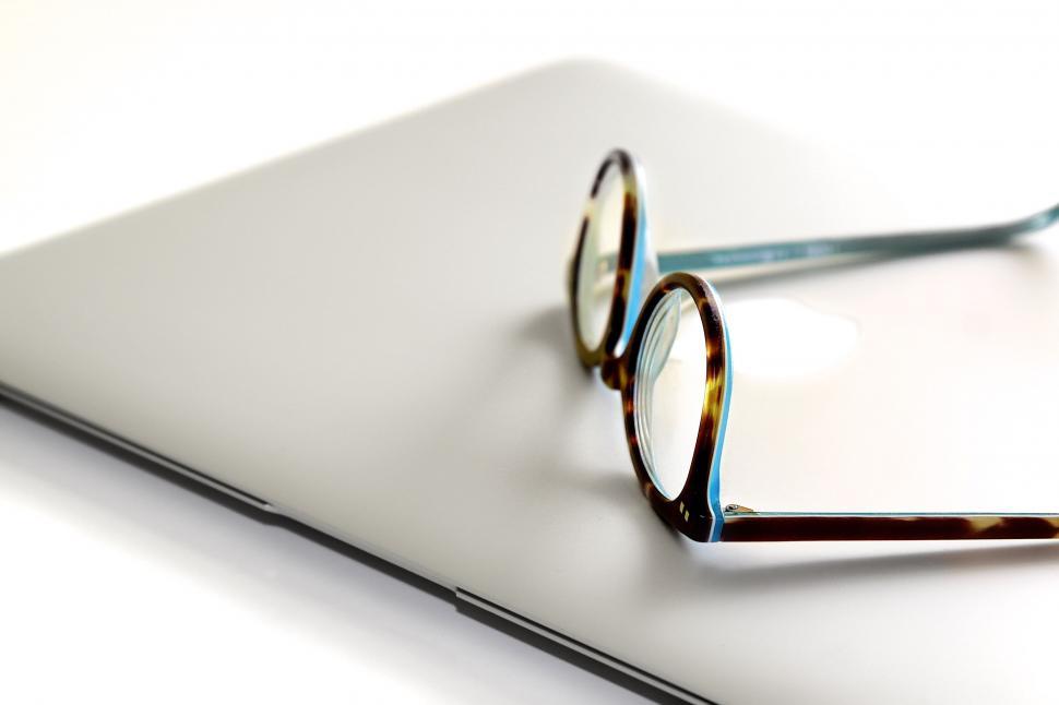 Free Image of A pair of glasses on a laptop 