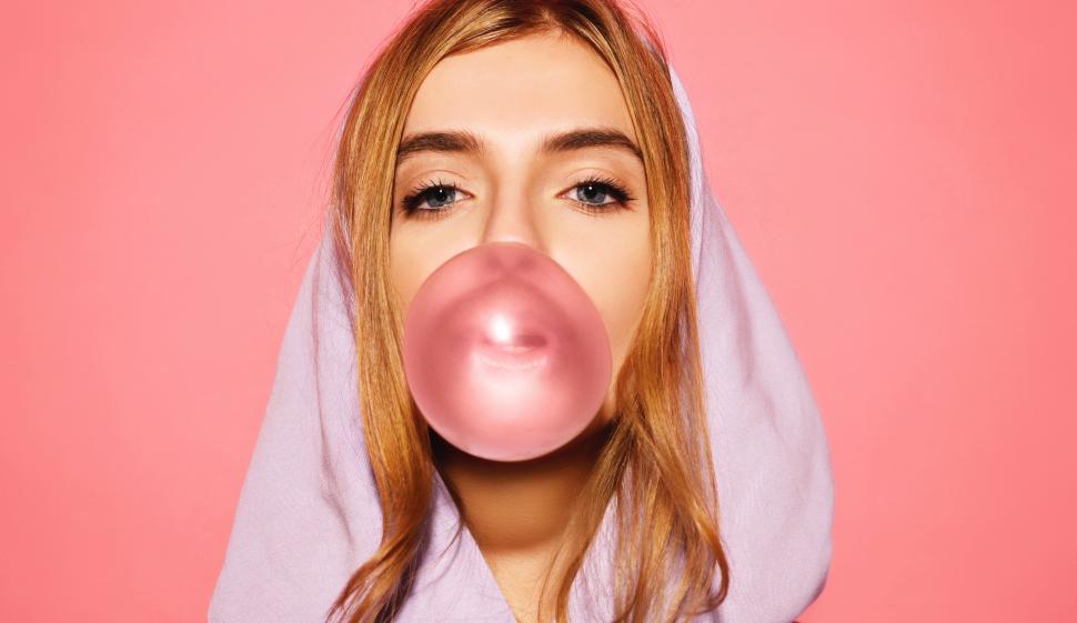 Free Image of A woman blowing a bubble 