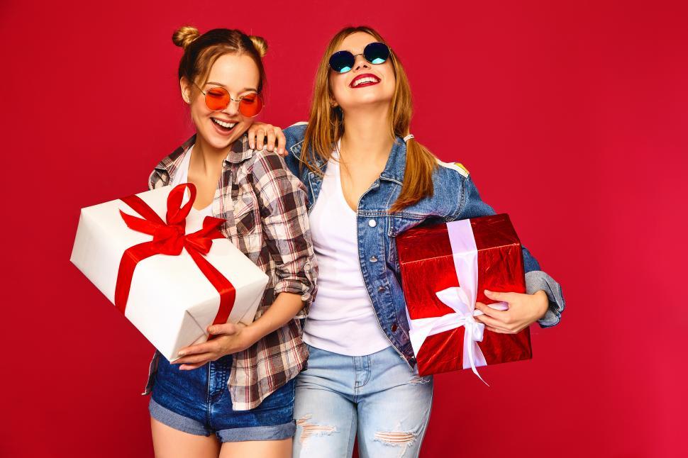 Free Image of Two women holding presents 