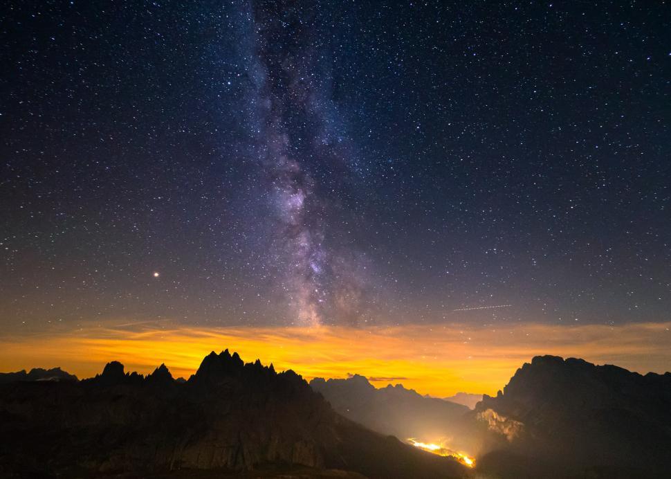 Free Image of A starry sky over mountains 