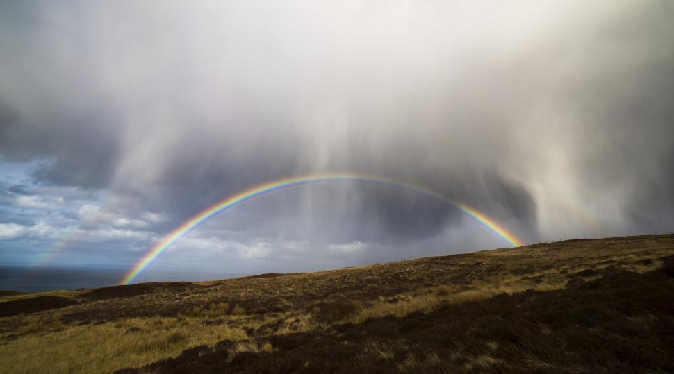 Free Image of A rainbow over a hill 