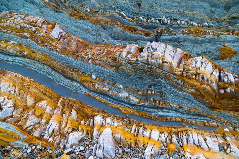 Free Image of A rock layers with orange and blue layers 