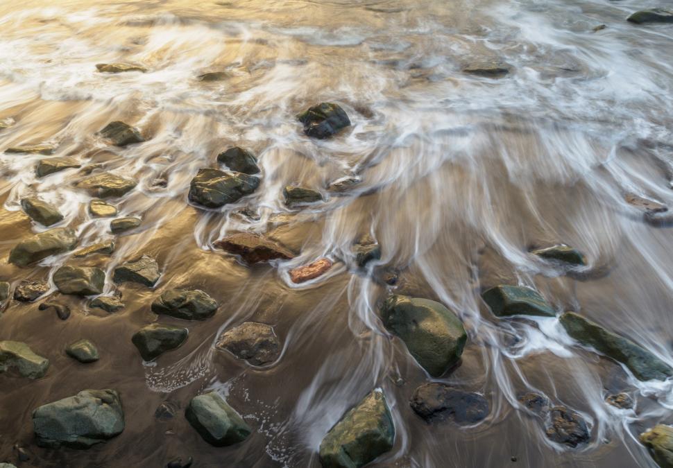 Free Image of Waves crashing onto rocks on a beach 