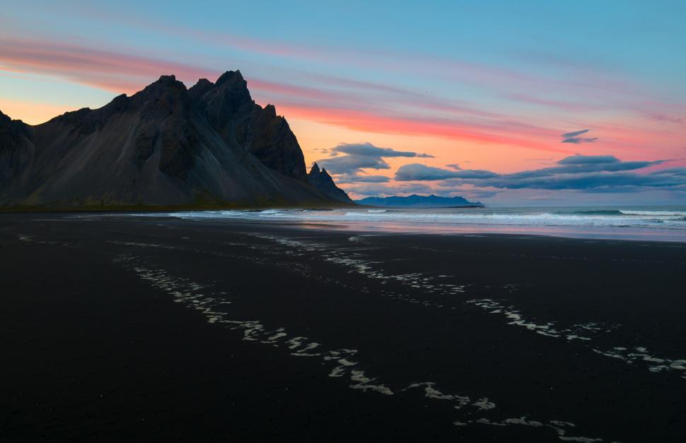 Free Image of A beach with a mountain in the background 