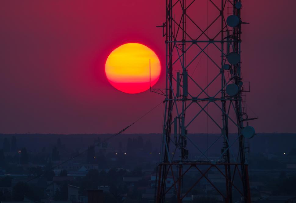 Free Image of A red and yellow sunset over a tower 