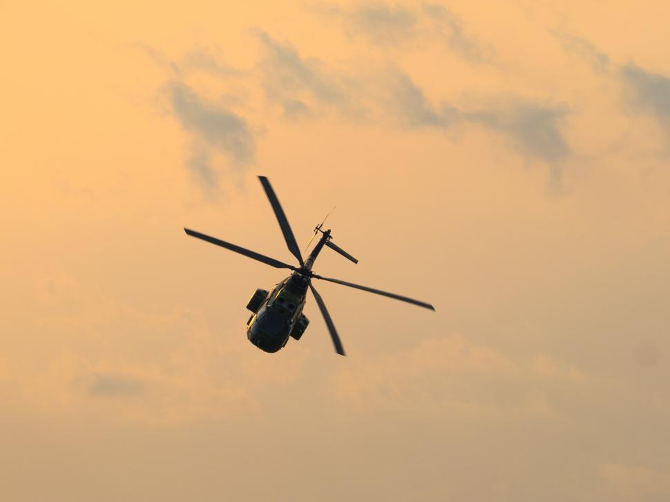 Free Image of A helicopter flying in the sky 