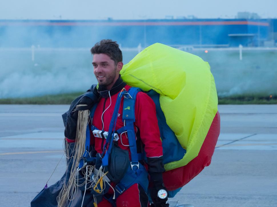 Free Image of A man in a suit with a parachute 