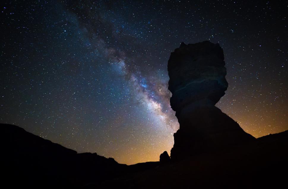 Free Image of A rock formation in the night sky 