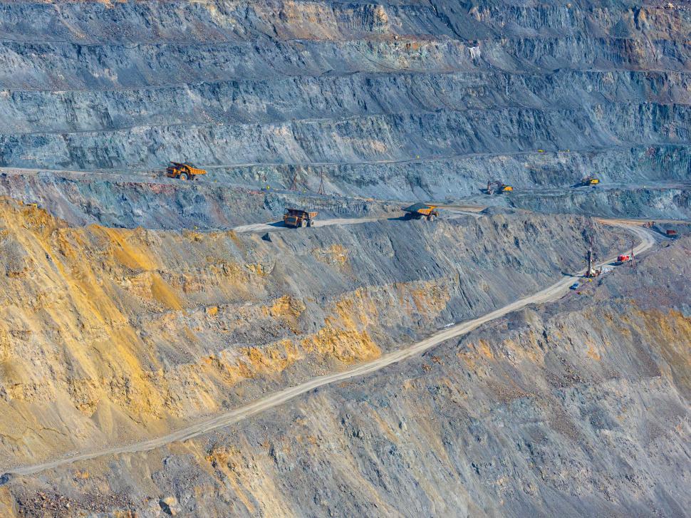 Free Image of A large quarry with trucks on it 